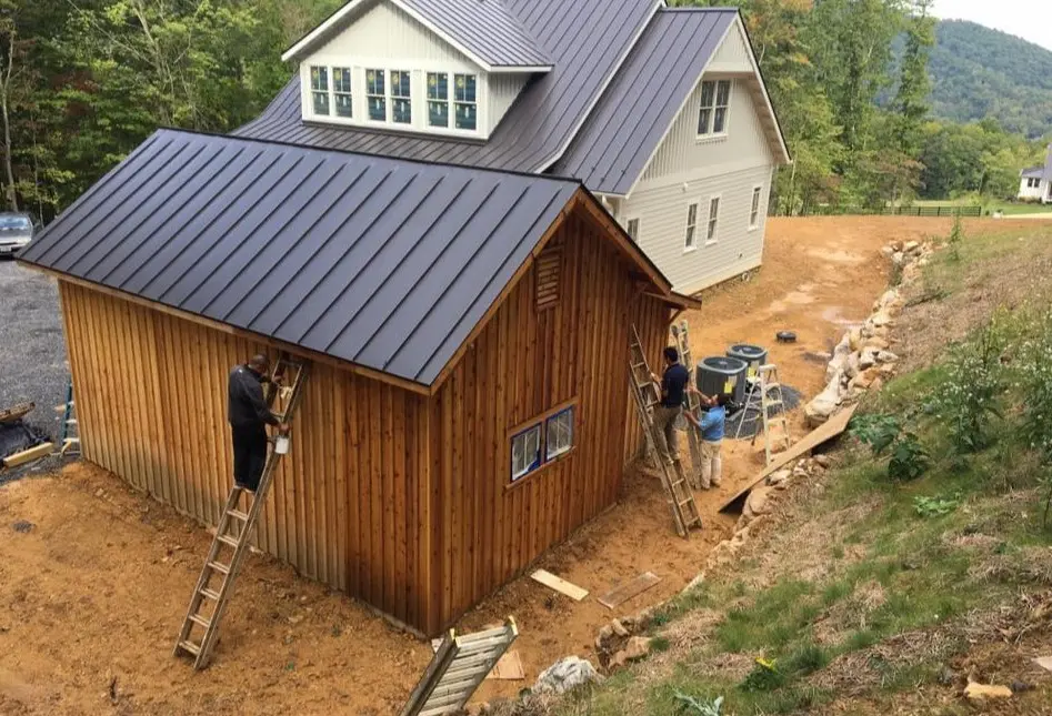 painting house exterior in eco sky construction & painting